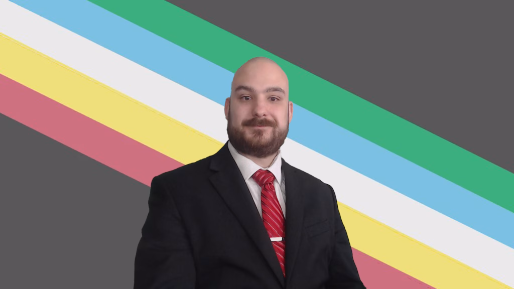 Ross, a person with a bald head and beard. He is wearing a black suit, white shirt, and red striped tie. Behind him is a gray background with diagonal stripes in green, blue, white, yellow, and red.